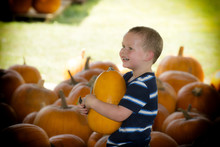 Young Boy Holding Pumpkin