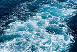 Fototapeta  - Natural background of blue-green sea water with foam and waves.
