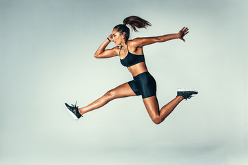 fit young woman jumping in air