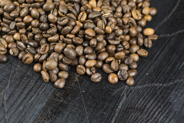 Coffee beans on a background of black wood