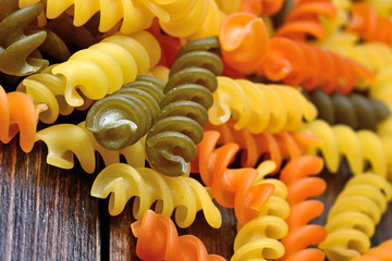 Wall Mural - Heap of colorful pasta on table