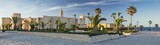 Fototapeta  - panorama with old fort and palm trees with blue sky in Tunisia