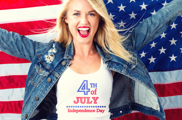 Happy young woman with an American flag on the fourth of July