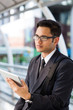 © kapturephoto - Young asian businessman outdoors