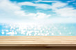 © Atstock Productions - Wood table top on blur shiny sea water and summer sky background