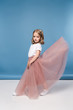 © LIGHTFIELD STUDIOS - Beautiful little girl in pink skirt posing in studio and looking at camera