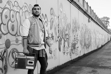 Wall Mural - Black and white photo of a man dressed in hip hop style