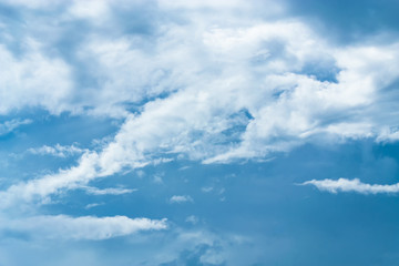 Blue sky background with tiny clouds. White fluffy clouds in the blue sky