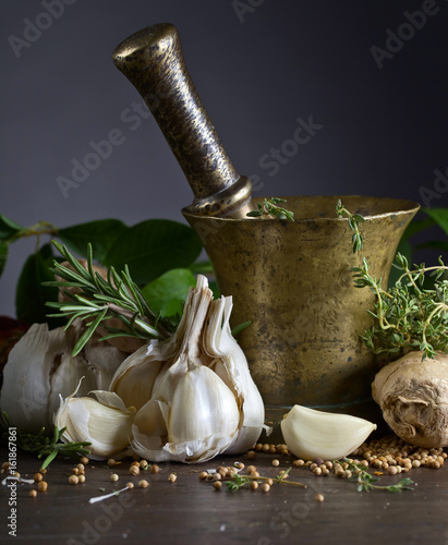 Fotografía Different herbs and spices on a wooden table .