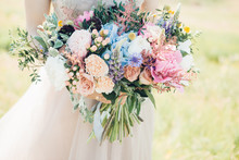 Bride's Hands Hold Beautiful Bridal Bouquet Of Peony. Fine Art Photography.