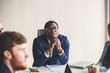 © alfa27 - black leader of the business people giving a speech in a conference room.
