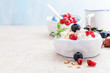 Cottage cheese with berries on light background. Copy space .