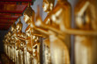 Row of gilded Buddhas, temple statues from Thailand
