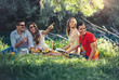 © Mediteraneo - Young people having picnic near the river. Young friends relaxing by the river