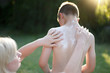 © sakkmesterke - Mother applying sunscreen creme for little son