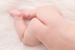 © portokalis - Close up baby bottom lying on white cloth background