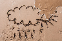 Sun With Cloud Drawing On Beach Sand