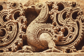 Wall Mural - Artwork on the Hindu temple walls with friezes, mythical swans and designed patterns. 12th centur Hoysaleshwara temple in Halebidu, India.