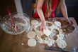 © Anna Larson - Girl cutting cookie dough on kitchen tabletop, high angle view