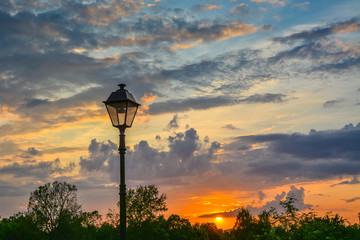 Lantern in retro style on a background of a colorful sunset