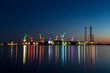 Colorful architectural lighting on giant cranes at night in Pula, Croatia