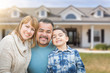 © Andy Dean - Mixed Race Family In Front Yard of Beautiful House and Property.