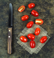 Wall Mural - Cherry tomatoes with basil leaf on a white background