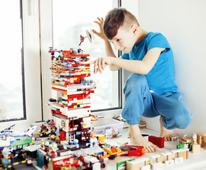 little cute preschooler boy playing Bricks toys at home happy smil