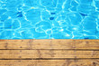 © tomertu - top view of swimming pool and wooden deck background