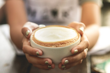 Cup of enery, Cappuccino coffee in white cup on wooden table