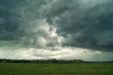 Fototapeta Morze - Clouds and rain over fields and forests