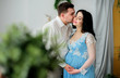© IVASHstudio - Hugging expacting couple stands in the room