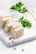 Tofu with fresh coriander on white background.
