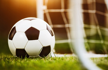 Wall Mural - Closeup soccer ball on green grass