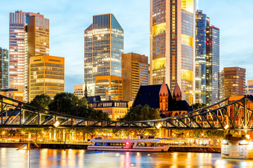 Wall Mural - Beautiful cityscape view on the illuminated skyscrapers and bridge during the twilight in Frankfurt, Germany