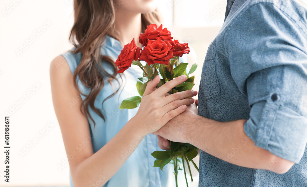 Hands of couple with beautiful bouquet, closeup