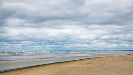 Sticker - low gray clouds over beach of Baltic Sea in autumn