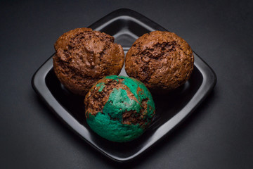 Chocolate cupcakes on black saucer