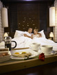 © eskay lim - loving couple having a lazy morning breakfast in comfy bed
