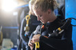 Girl dressing up with scuba diver's equipment