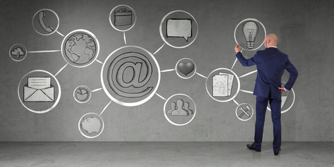 Wall Mural - Businessman drawing multimedia interface sketch on a wall 3D rendering
