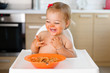 © Lisa Tichané - laughing toddler with messy face eating pasta