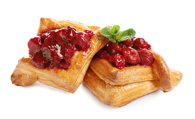 Wall Mural - Delicious puff pastries with cherry on white background