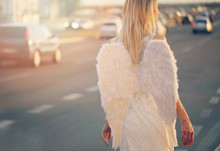 Young Beautiful Woman With Angel Wings Walking Near Highway, Freedom Concept