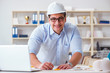 © Elnur - Male engineer working on drawings and blueprints