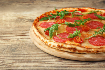 Sticker - Pizza with salami on wooden background