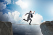 © Elnur - Businessman walking on tight rop in business concept