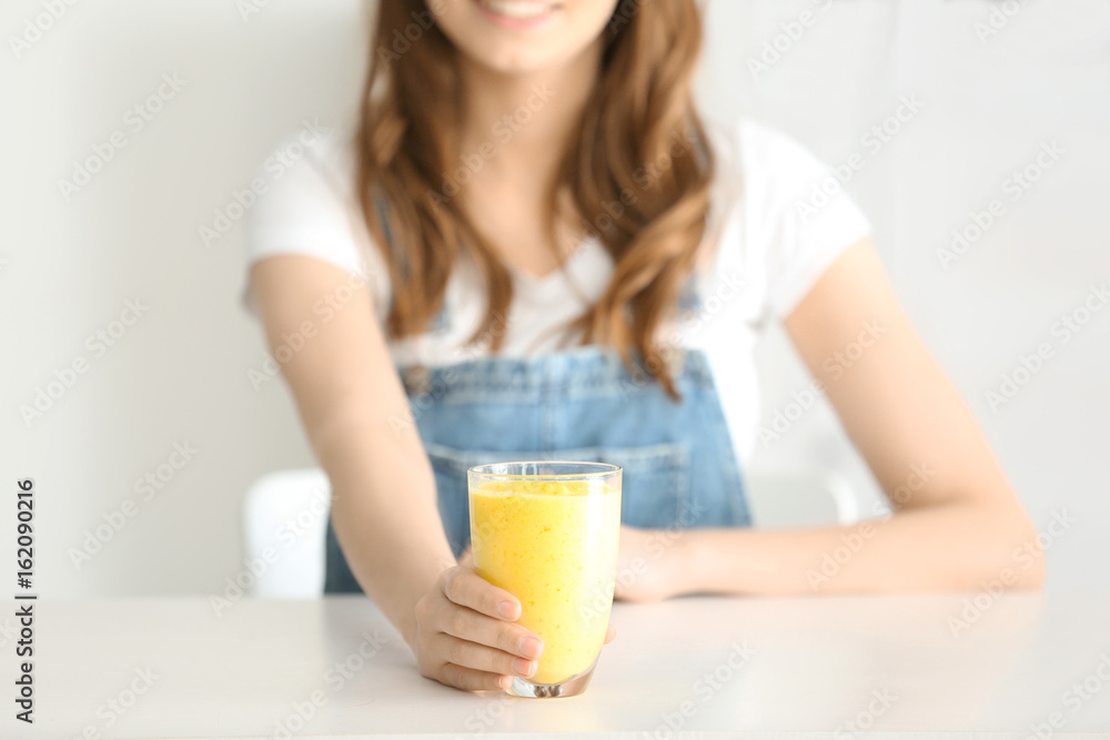 Weight loss concept. Beautiful young woman sitting at table with healthy delicious smoothie