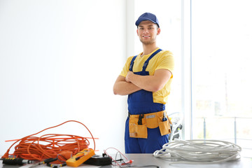 Wall Mural - Young electrician at workplace