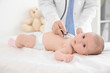 © Africa Studio - Doctor examining little baby with stethoscope in clinic. Baby health concept